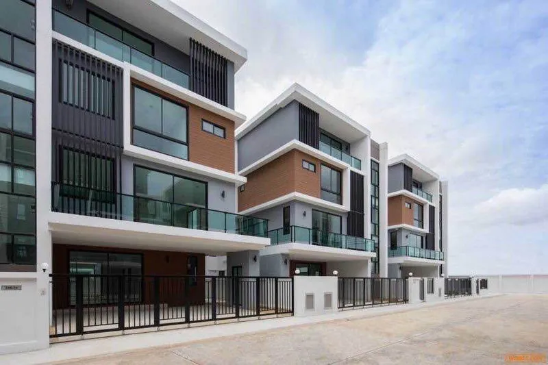 article image - Modern townhouse complex with glass balconies, multi-level design, and a sleek facade under a partly cloudy sky. Modern townhouse complex with glass balconies, multi-level design, and a sleek facade under a partly cloudy sky.