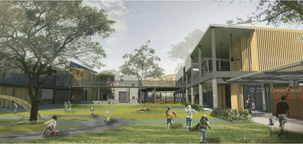 Children playing outdoors in a grassy area surrounded by modern buildings and trees.