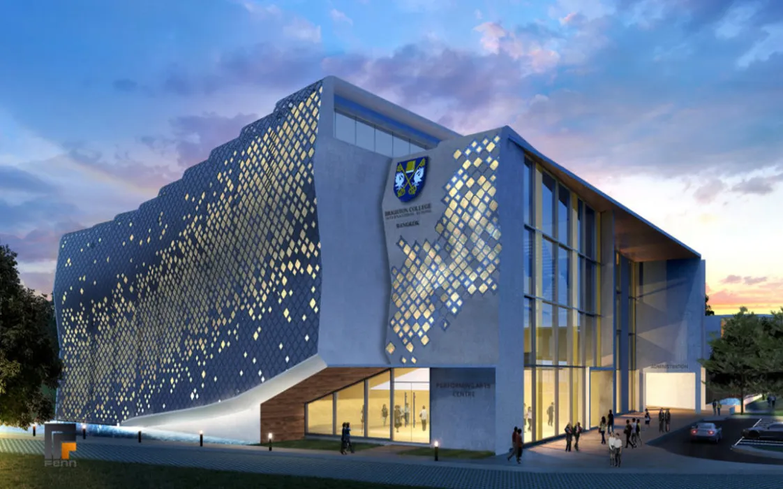 Modern building with a geometric facade, large glass windows, and people entering a well-lit interior during sunset.