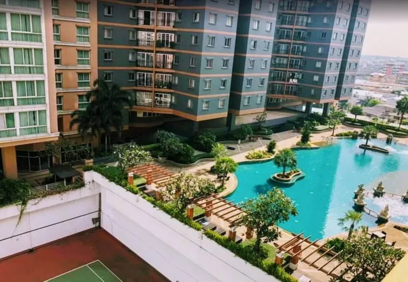 Apartment complex with pool, landscaped gardens, and tennis court.