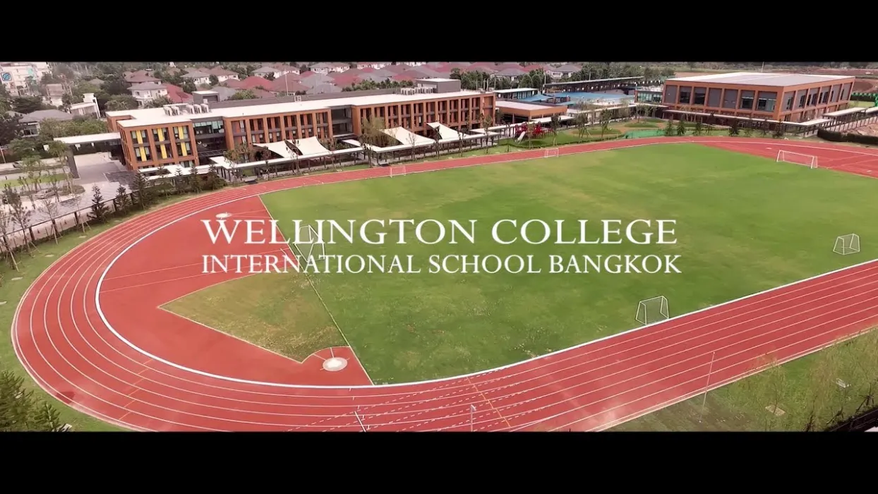 Aerial view of Wellington College International School Bangkok with a red running track and green sports field.