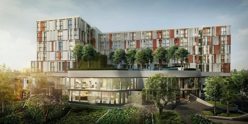 Modern multi-story building with greenery on the rooftop and large glass windows, surrounded by trees and landscaped gardens.