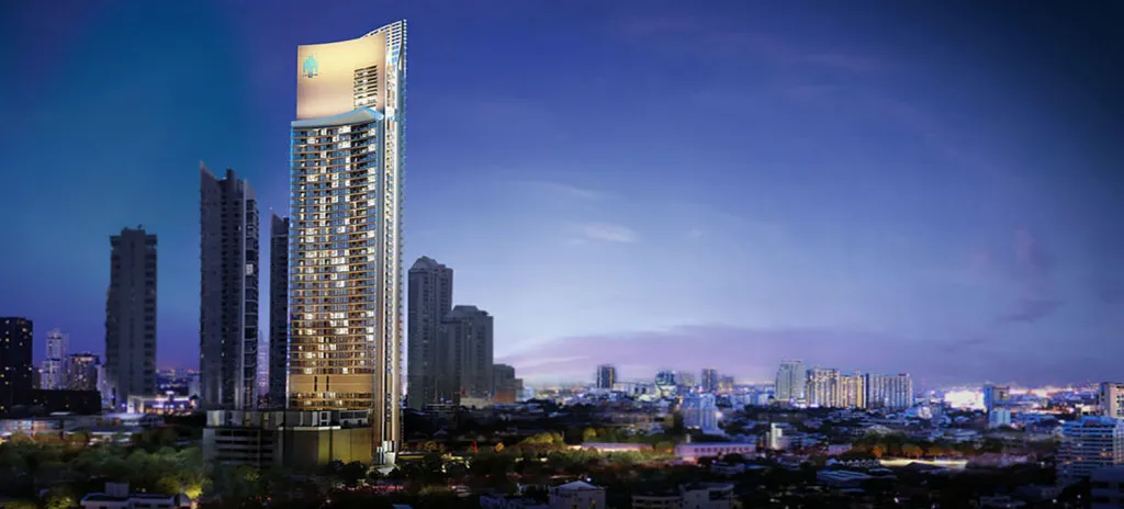 A modern skyscraper in a cityscape at dusk, with illuminated windows and a skyline backdrop.