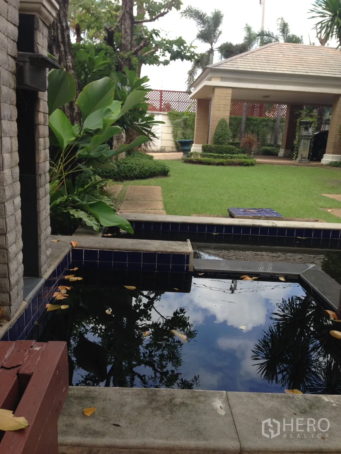 Detached House for rent or sale in Suan Luang, Bangkok - Backyard lawn with covered pavilion, tropical plants and blue-tiled reflecting pond.