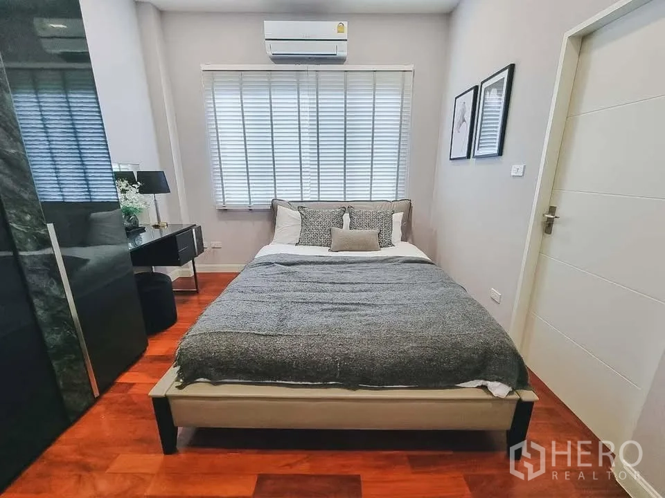Detached House for rent or sale in Bang Phli, Samut Prakan - Cozy bedroom with double bed, window blinds, and air conditioner.