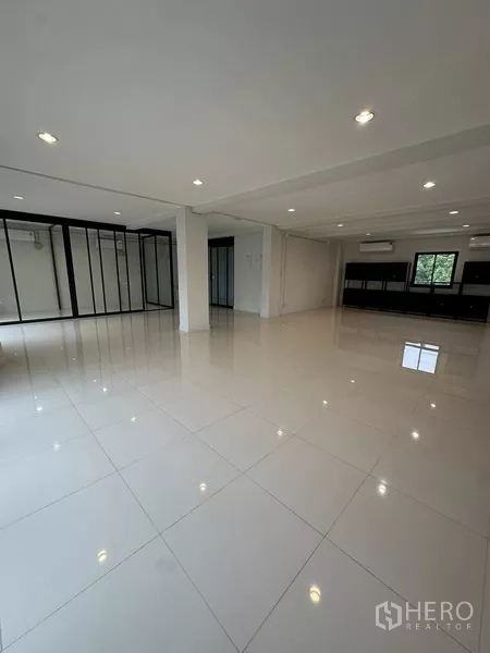 Home Office for rent - Expansive bright office level with glossy tiles and multiple glass rooms.