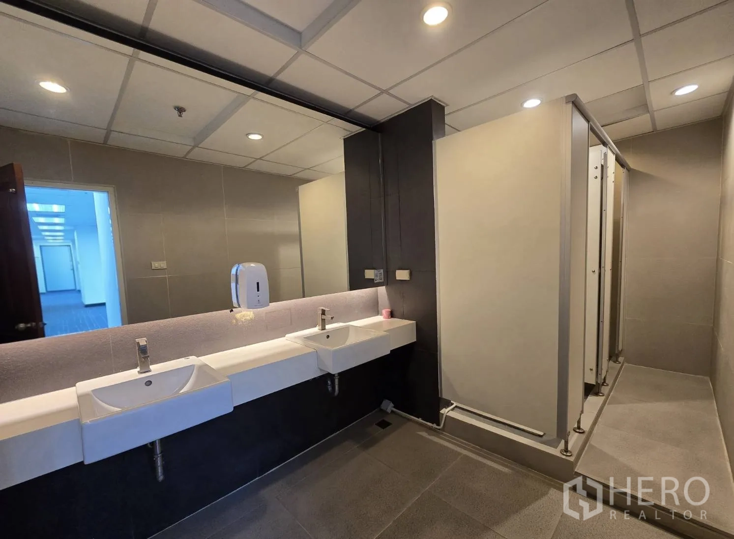 Office Space for rent in Watthana, Bangkok - Restroom with double sinks, large mirror, and toilet stalls.