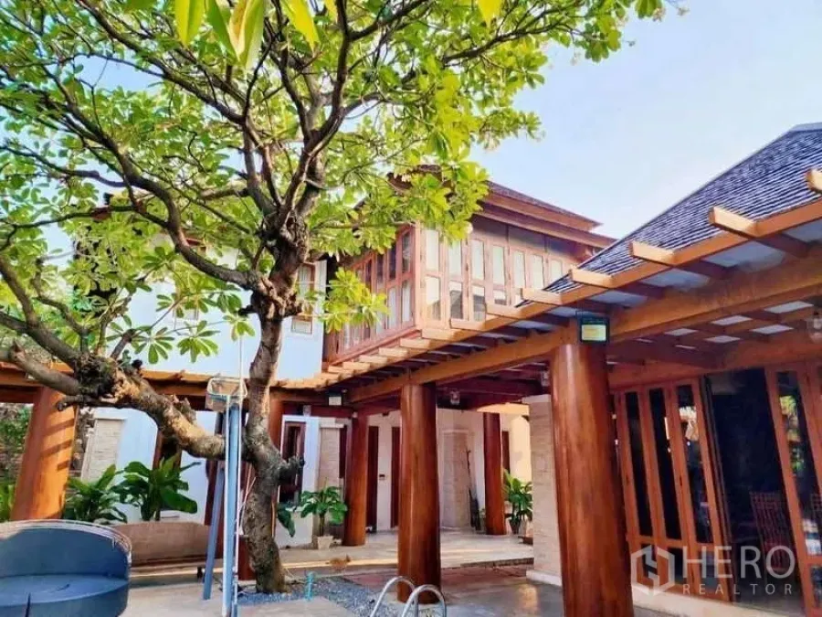 Detached House for sale in Bueng Kum, Bangkok - Two-story pavilion with extensive windows, pergola beams and tree by the pool.