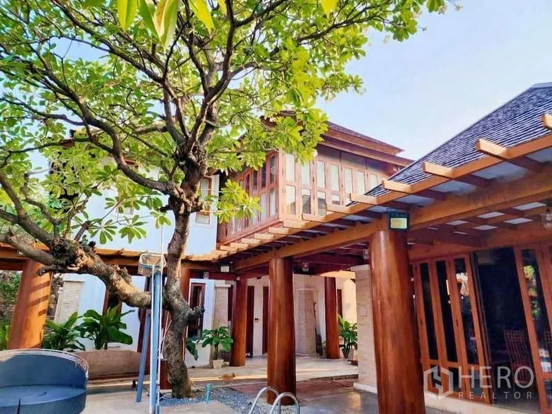 Detached House for sale in Bueng Kum, Bangkok - Two-story pavilion with extensive windows, pergola beams and tree by the pool.