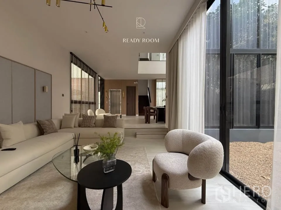 Detached House for rent in Bang Kapi, Bangkok - View from living room toward dining area and staircase with garden‑side glazing.