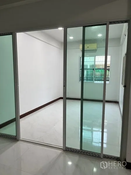 ทาวน์เฮาส์ ให้เช่าในDin Daeng, Bangkok - เฉลียงหน้าบ้าน/ที่จอดรถแบบมีหลังคา ปูกระเบื้องลายวงกลมและประตูกระจกบานเลื่อน.