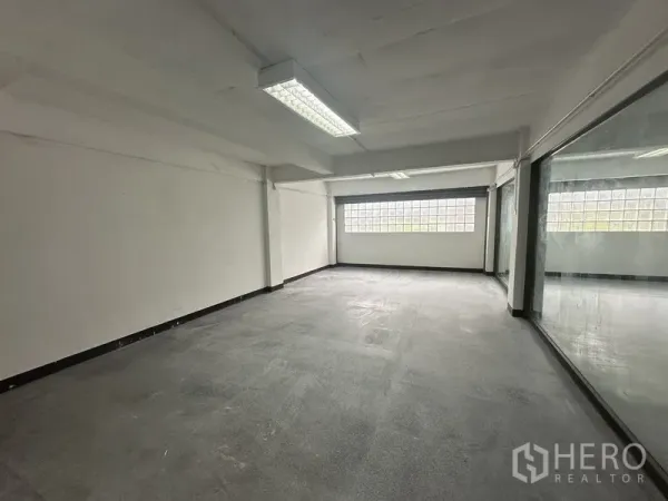 Office Space for rent in Khlong Toei, Bangkok - Enclosed office room with a large internal glass wall and glass-block window.