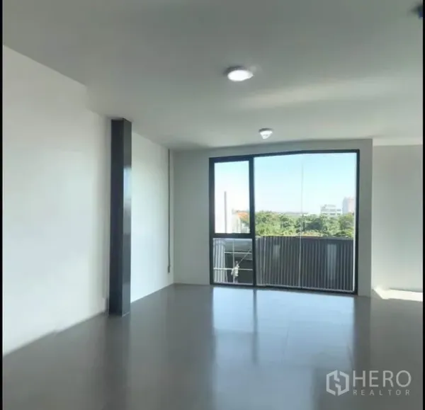 Office Space for rent in Wang Thonglang, Bangkok - Bright office space with large window and balcony overlooking greenery.