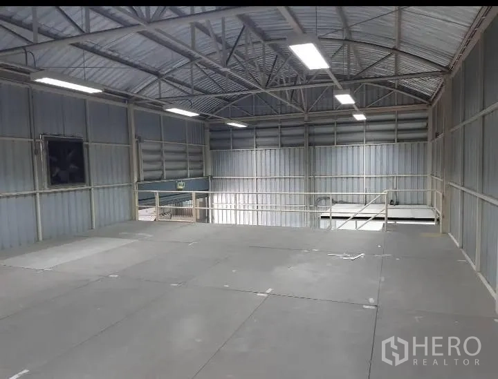 Warehouse for rent in Bang Kho Laem, Bangkok - Mezzanine level with guardrails, linear lighting, and a wall ventilation fan.
