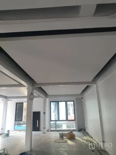 Office Space for rent in Khlong Toei, Bangkok - Bright open office floor with high ceiling, support columns, and large windows.