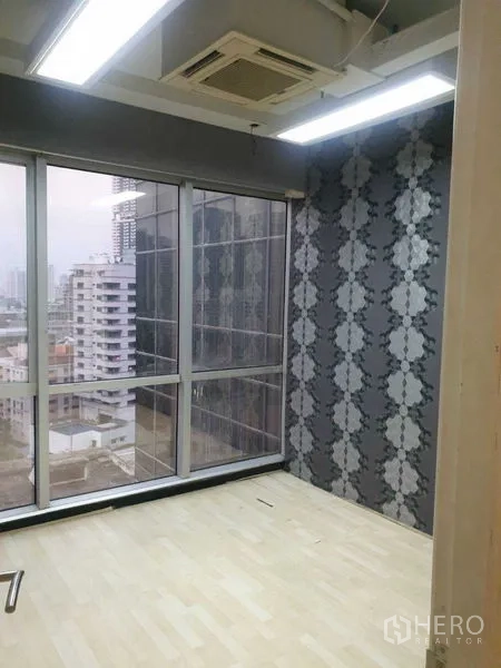 Office Space for rent - Small meeting room with patterned grey feature wall and floor-to-ceiling windows.