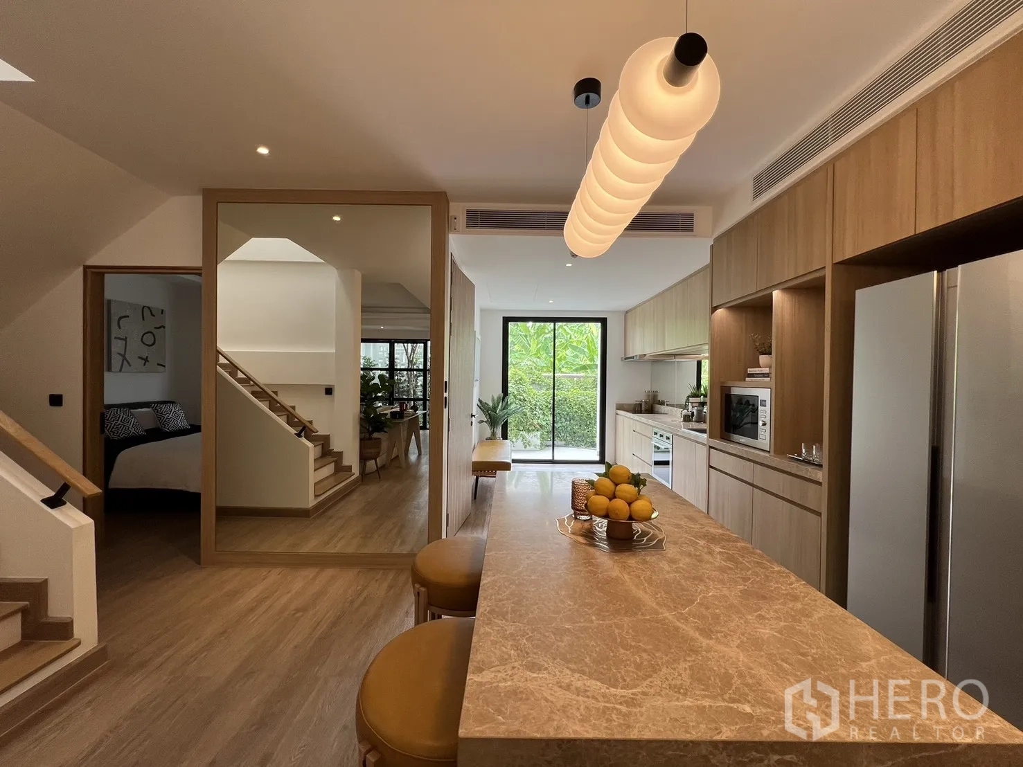 Townhouse for sale in Watthana, Bangkok - Stairwell topped by a large skylight and blue abstract artwork.