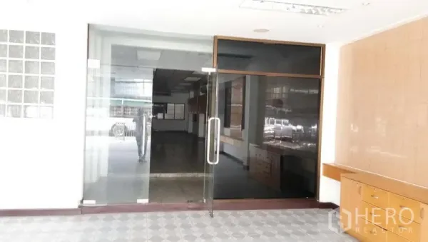 Office Space for rent in Sathon, Bangkok - Glass double-door entrance leading to a bright office lobby with display counter.