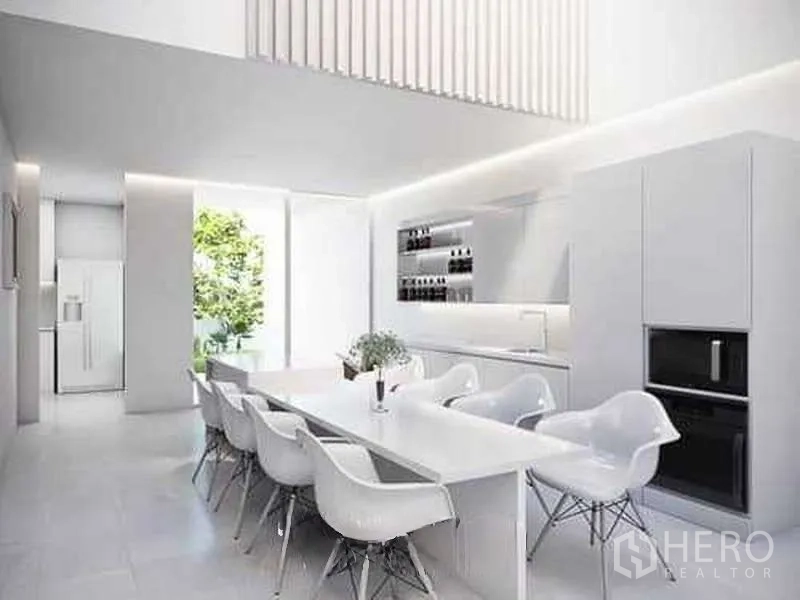 Home Office for rent in Bang Phli, Samut Prakan - Bright white kitchen with island-style dining table, sleek cabinetry and integrated appliances.