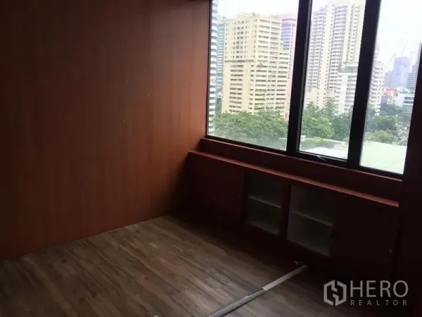 Office Space for sale in Watthana, Bangkok - Windowed private office with wood finishes and urban greenery views.