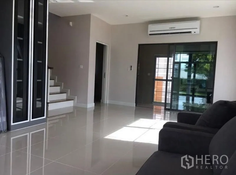 บ้าน ขายในPrawet, Bangkok - โถงนั่งเล่นแบบเปิดโล่ง พื้นกระเบื้องเงา บันได และประตูกระจกบานเลื่อน