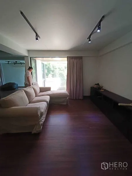 Home Office for rent in Watthana, Bangkok - Upper living room with sofa, wide window and wood floor.