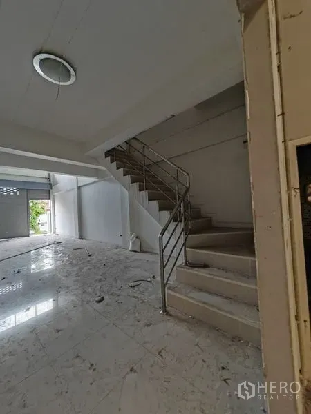 Home Office for rent or sale in Lam Luk Ka, Pathum Thani - Open ground floor with tiled floors and a metal staircase leading to upper office levels.