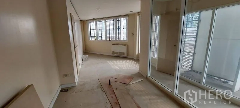 Shophouse for sale - Corridor with glass partitions and abundant natural light.