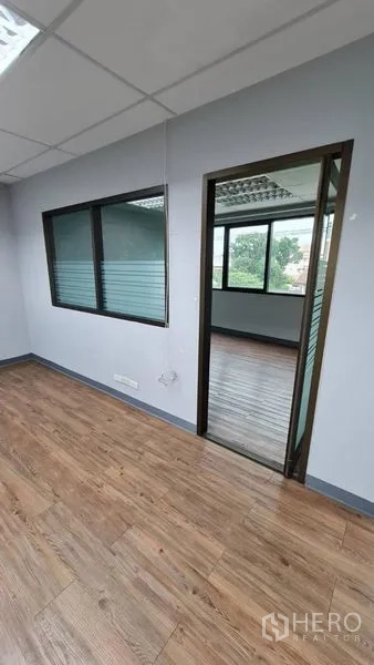 Office Space for rent in Watthana, Bangkok - Internal corridor with windowed partition and doorway to an adjacent room.
