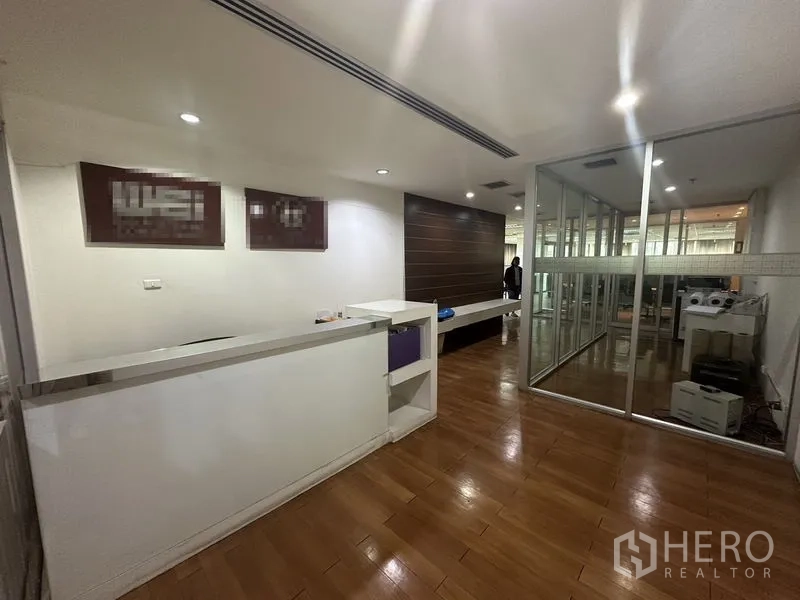 Office Space for rent - Reception area with front desk, wood accent wall and glass partitions