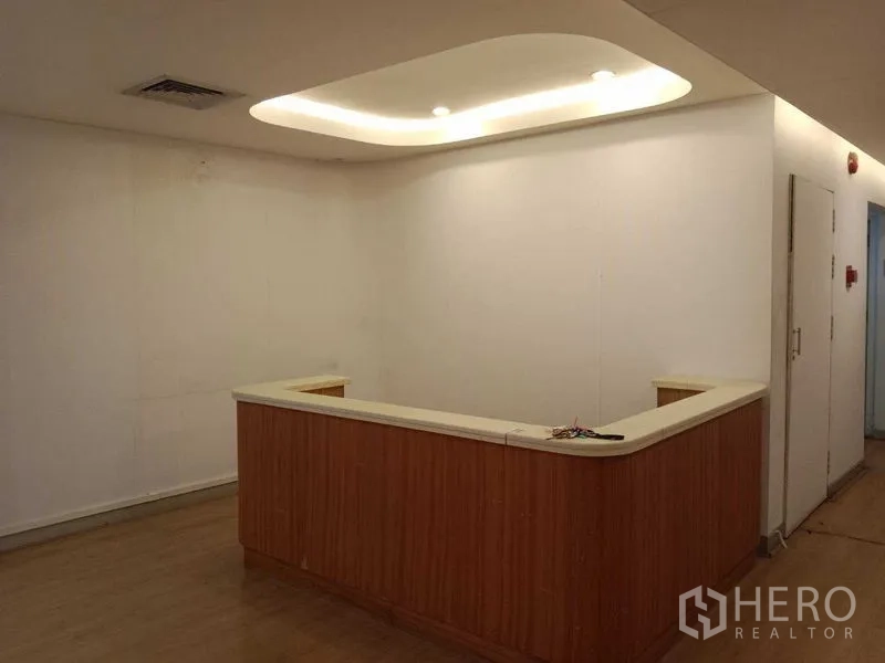 Office Space for rent in Watthana, Bangkok - Built-in reception counter with cove lighting in a corner lobby.