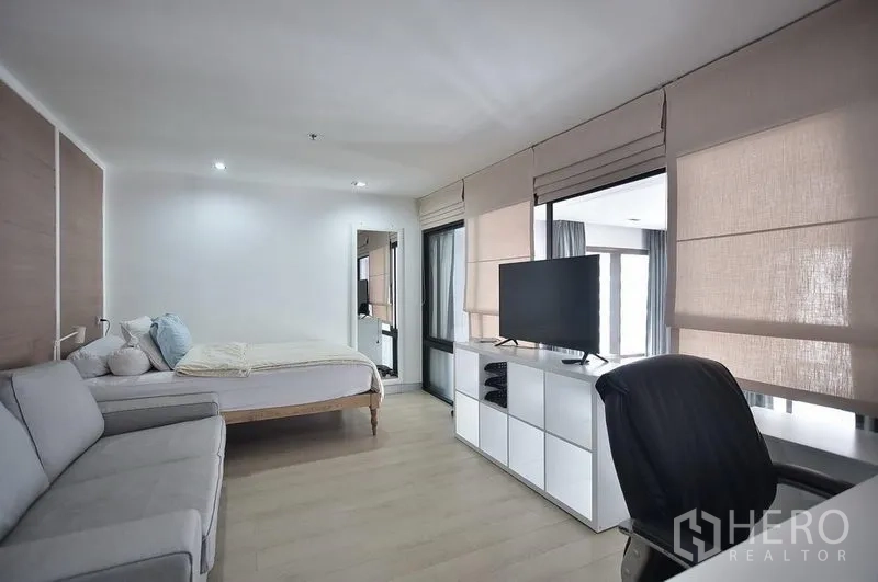 คอนโด ให้เช่าในKhlong Toei, Bangkok - ห้องนอนชั้นบนมีโซฟา หน้าต่างบานใหญ่พร้อมมู่ลี่ ชั้นวางทีวี และพื้นไม้โทนอ่อน