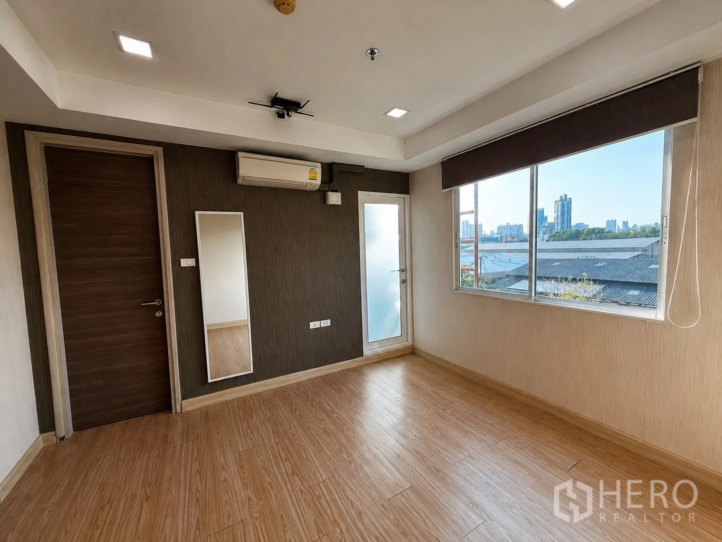 Home Office for rent or sale in Yan Nawa, Bangkok - Upper-floor room with large windows, city view, and a door to a small balcony.
