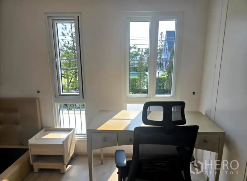 Detached House for rent in Bang Phli, Samut Prakan - Work desk facing tall windows with green neighborhood views.