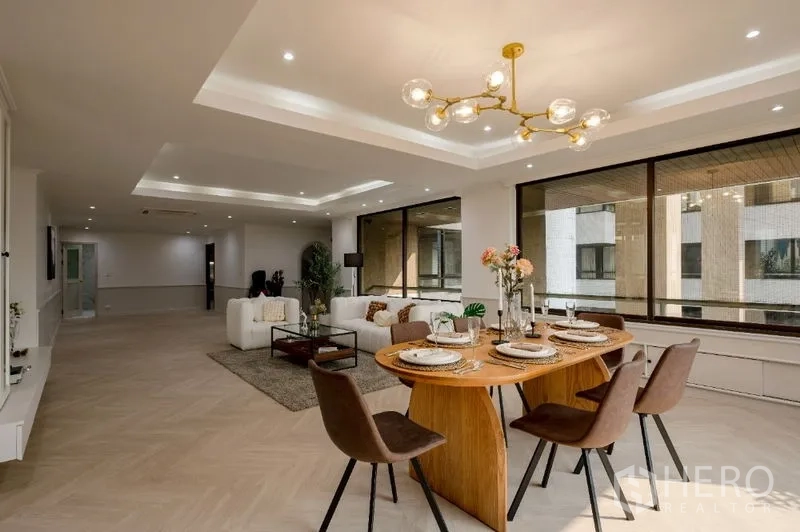 Condominium for sale - Dining and lounge under tray ceilings with soft recessed lighting.