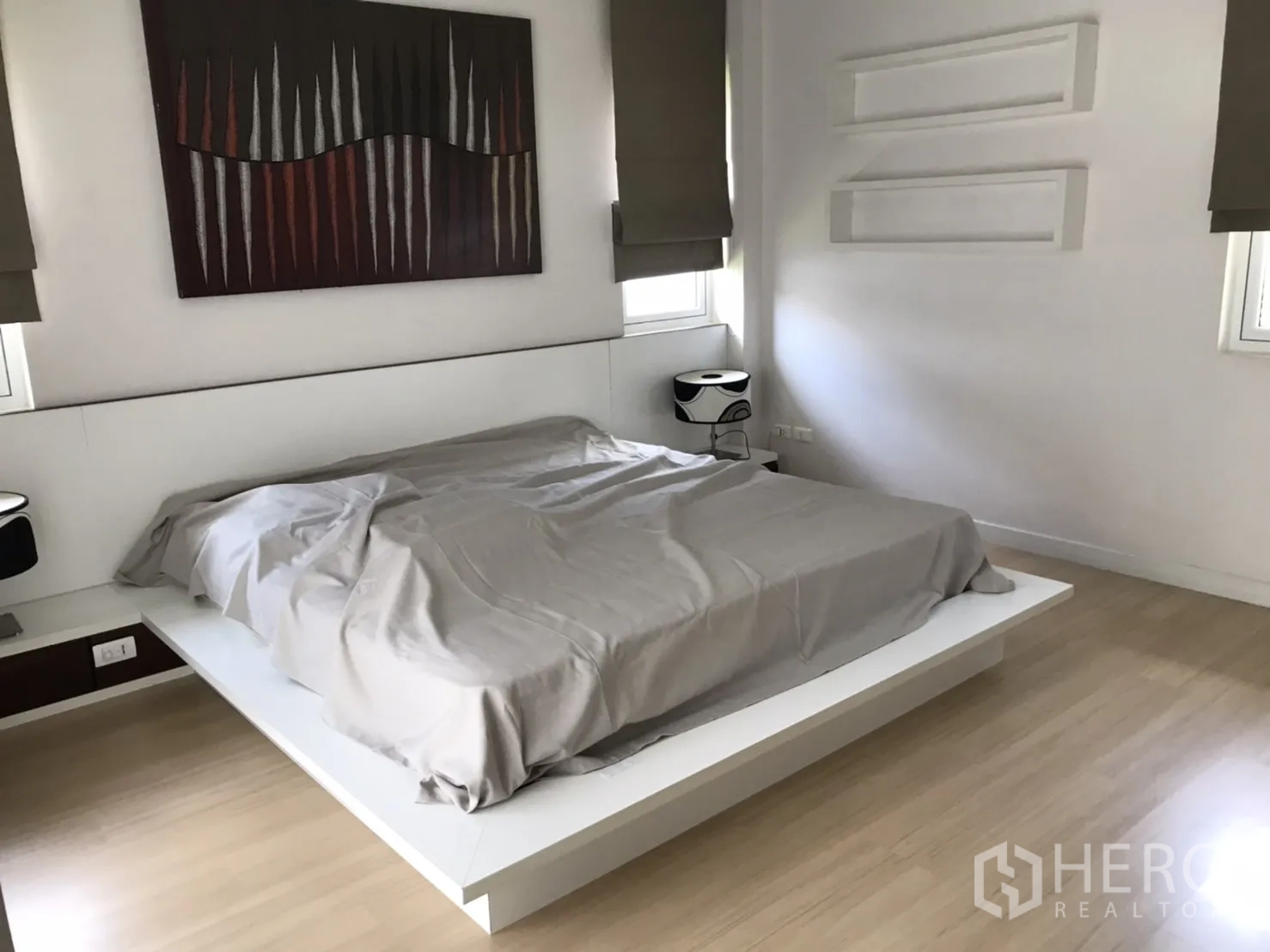 独立式住宅 出租或出售在Saphan Sung, Bangkok - 主卧配平台床、木地板与现代装饰画。