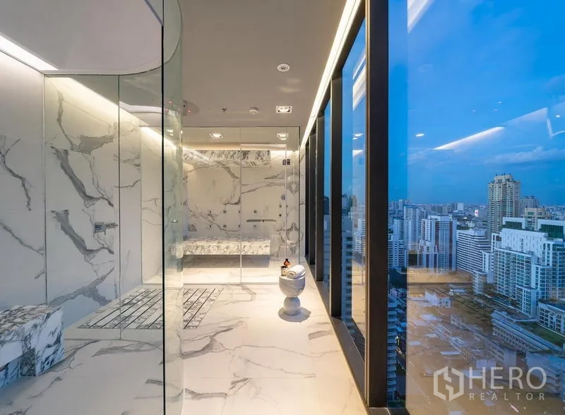 Condominium for rent in Watthana, Bangkok - Sky-level marble steam room with glass walls and panoramic Bangkok skyline views.