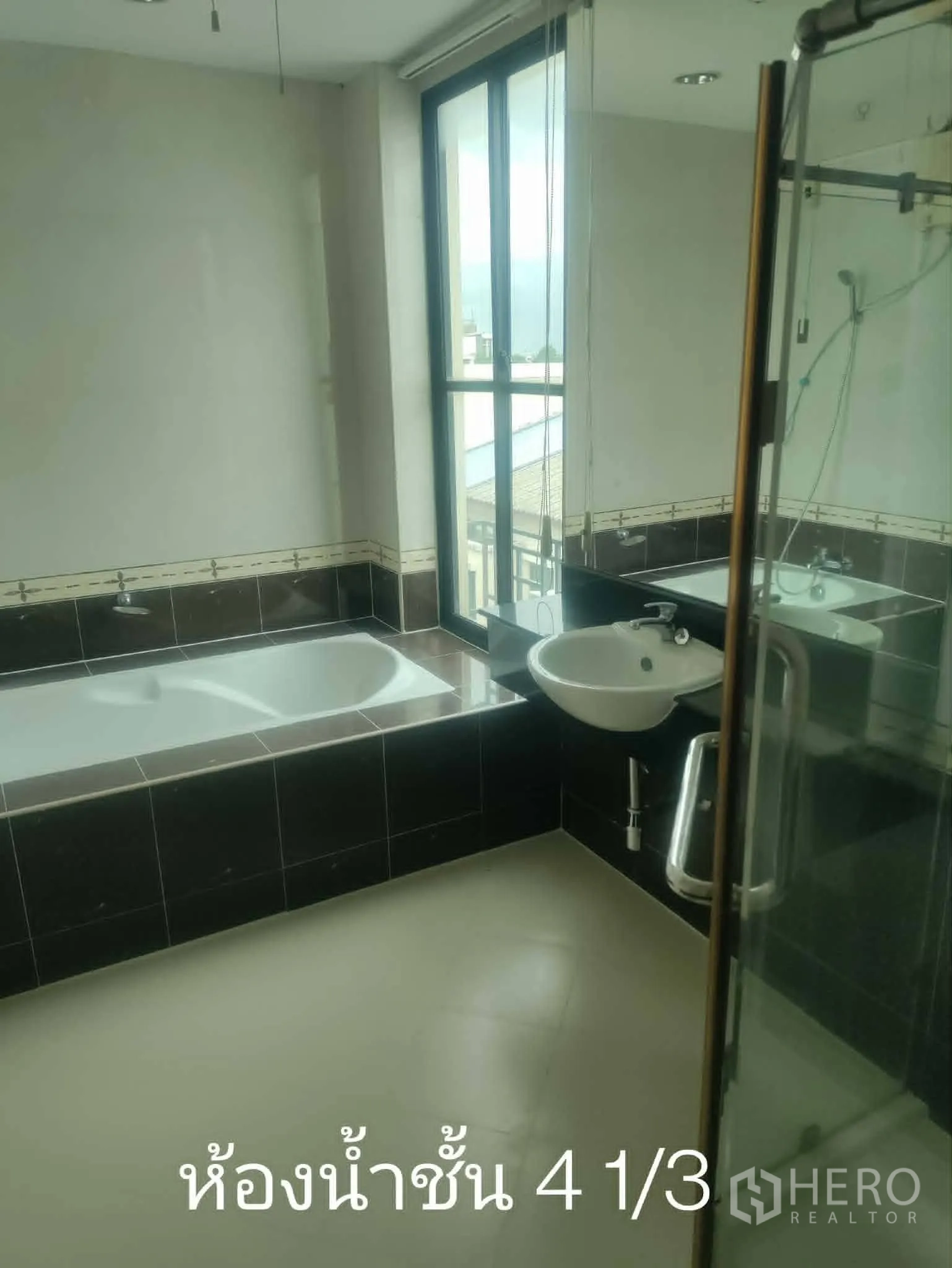 Home Office for rent in Lat Phrao, Bangkok - Bathroom featuring bathtub, large window, and separate shower.