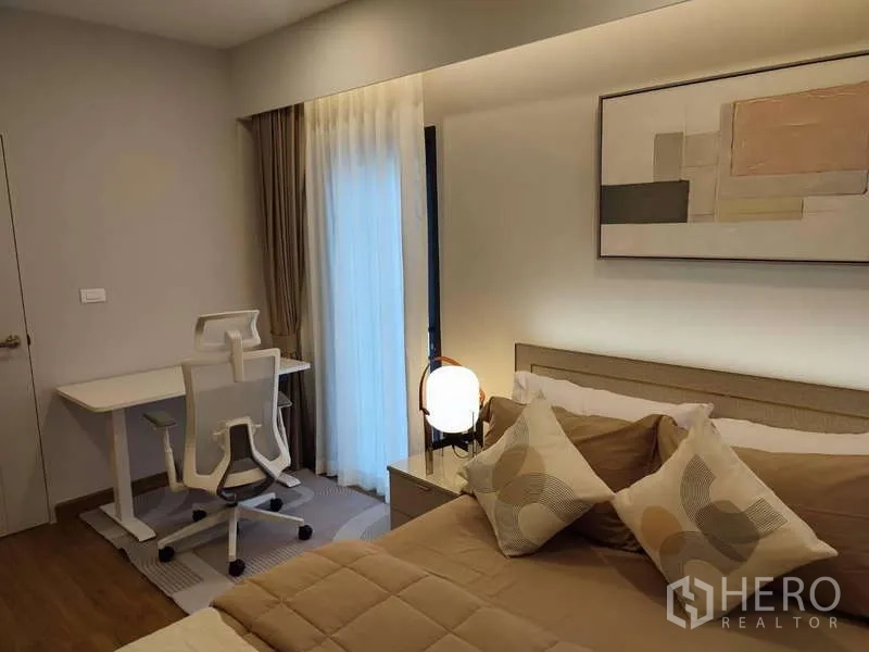 Detached House for rent in Bang Phli, Samut Prakan - Cozy bedroom with bed, study desk, warm lighting and curtained sliding door.