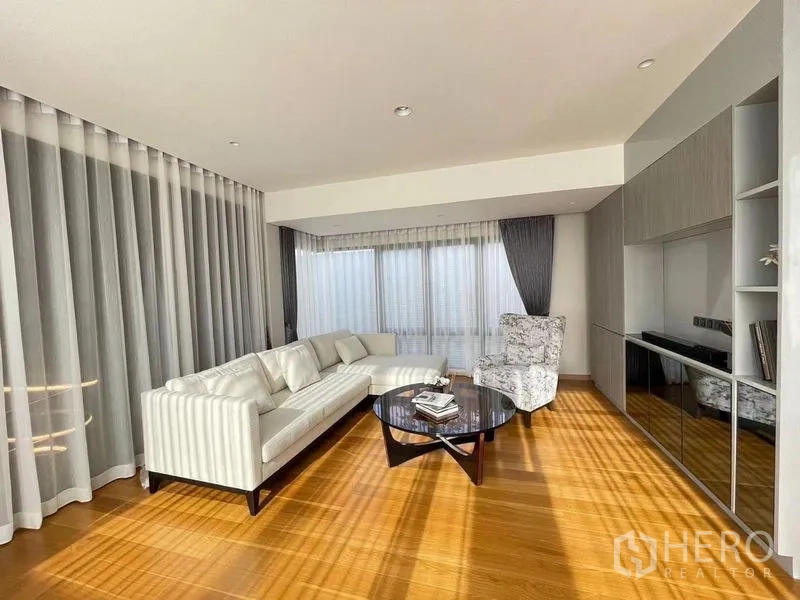 Detached House for sale in Suan Luang, Bangkok - Bright upstairs family lounge with L-shaped sofa, coffee table and sheer curtains over wood floors.