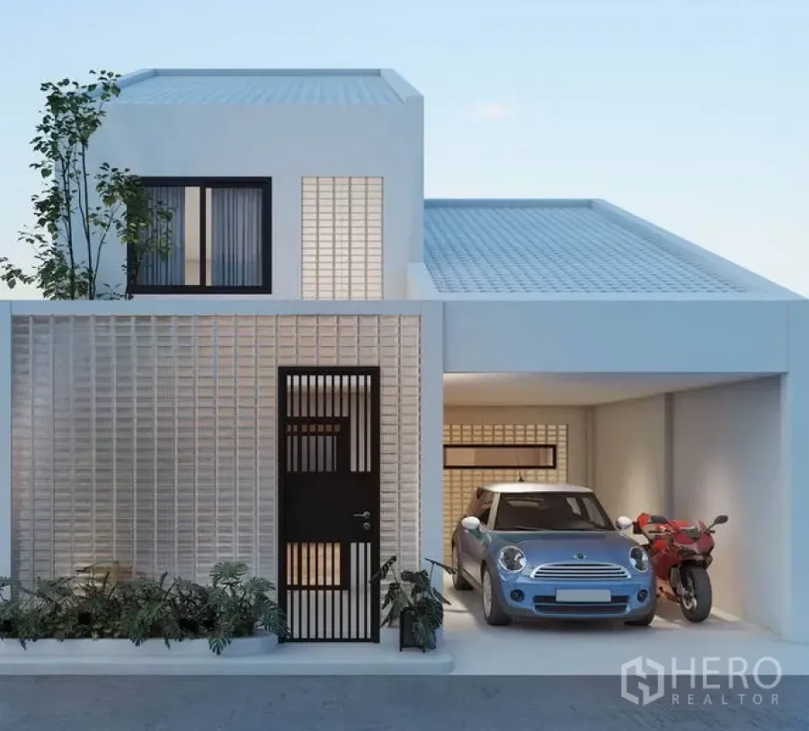 Detached House for rent in Watthana, Bangkok - Modern white two-storey detached house with breeze-block facade and a covered carport for a car and motorcycle.