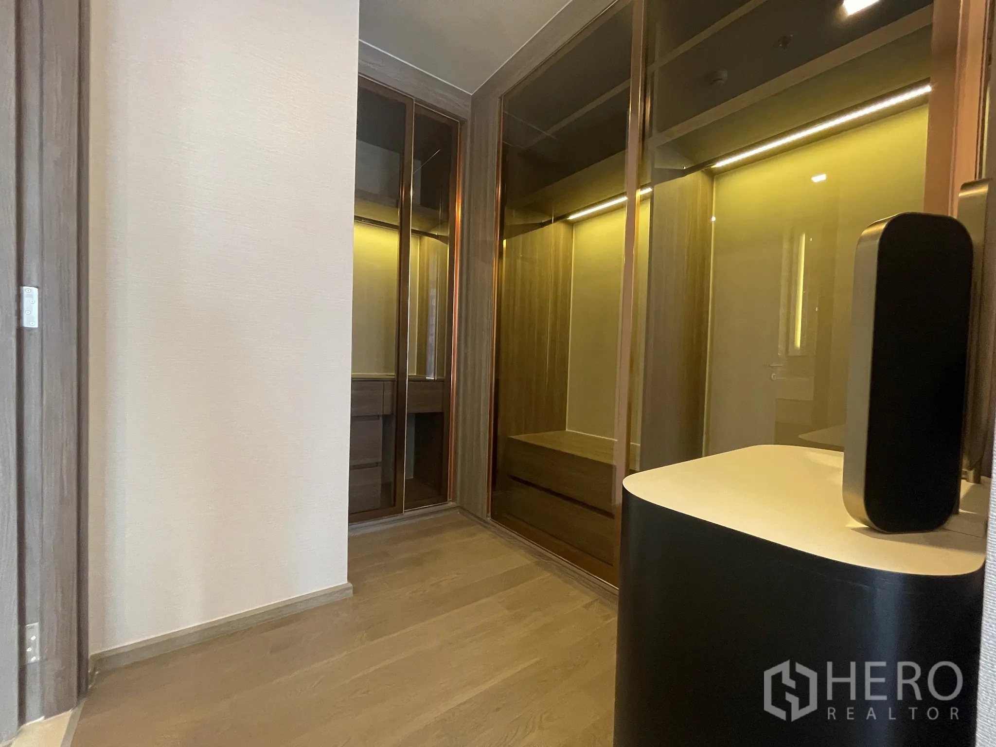Condominium for rent in Watthana, Bangkok - Hallway to the dressing area featuring illuminated wardrobes.