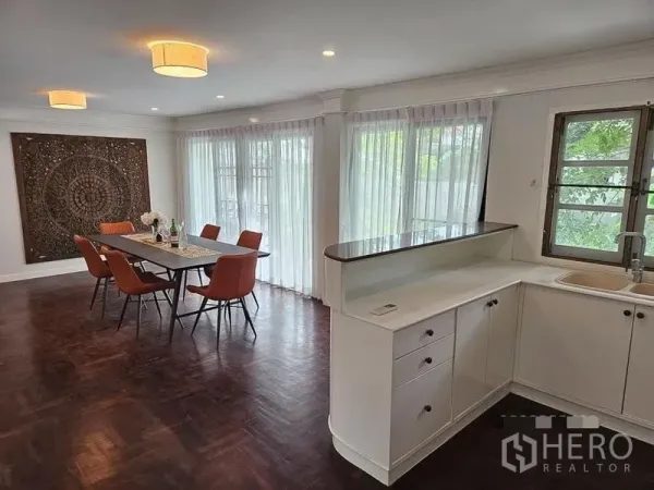 Detached House for rent - Open dining area beside a pantry-style counter and windows dressed with sheer curtains.