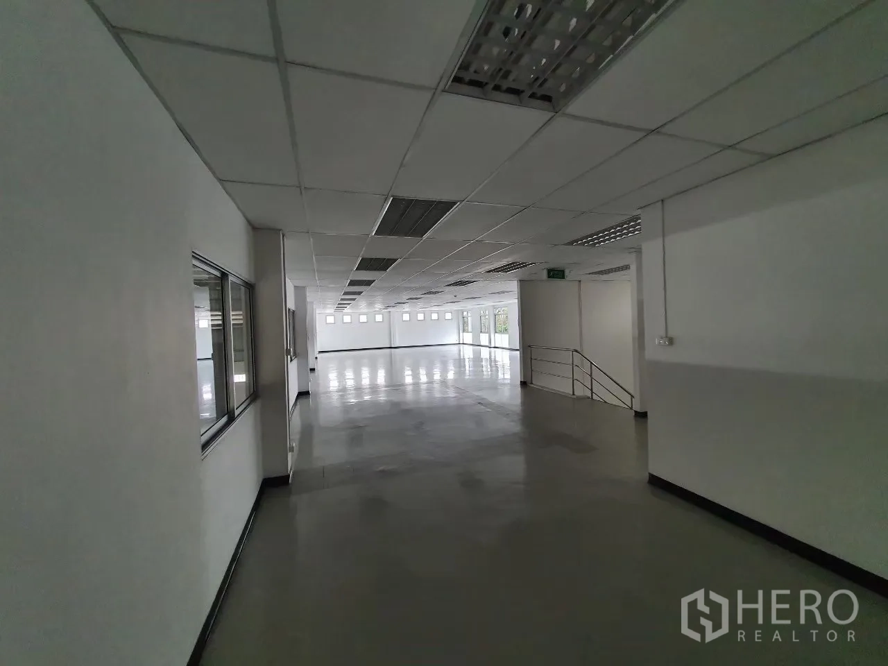 Factory for rent in Bang Pa-in, Phra Nakhon Si Ayutthaya - Bright office corridor with drop ceiling, windows, and stair access.