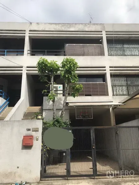 Home Office for rent or sale in Phra Khanong, Bangkok - Three-storey home office facade with gated entrance, balconies and small trees.