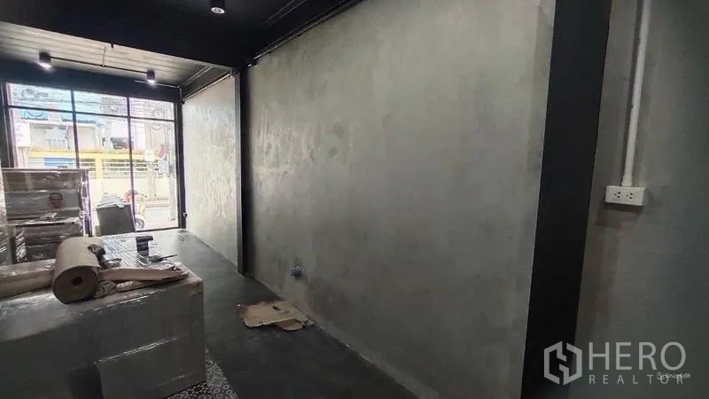 Shophouse for rent in Bang Kho Laem, Bangkok - Ground-floor retail space with polished concrete floors and a large street-facing window.