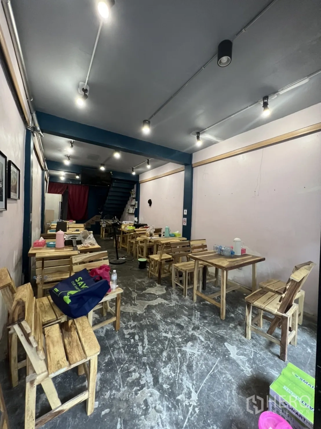 อาคารพาณิชย์ ให้เช่าในWatthana, Bangkok - พื้นที่ค้าปลีกชั้นล่าง เพดานเดินท่อไฟ พื้นคอนกรีต โต๊ะไม้ และบันไดขึ้นชั้นบน