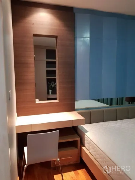 联排别墅 出租在Phra Khanong, Bangkok - 卧室角落带梳妆台、镜子与座椅，毗邻床位