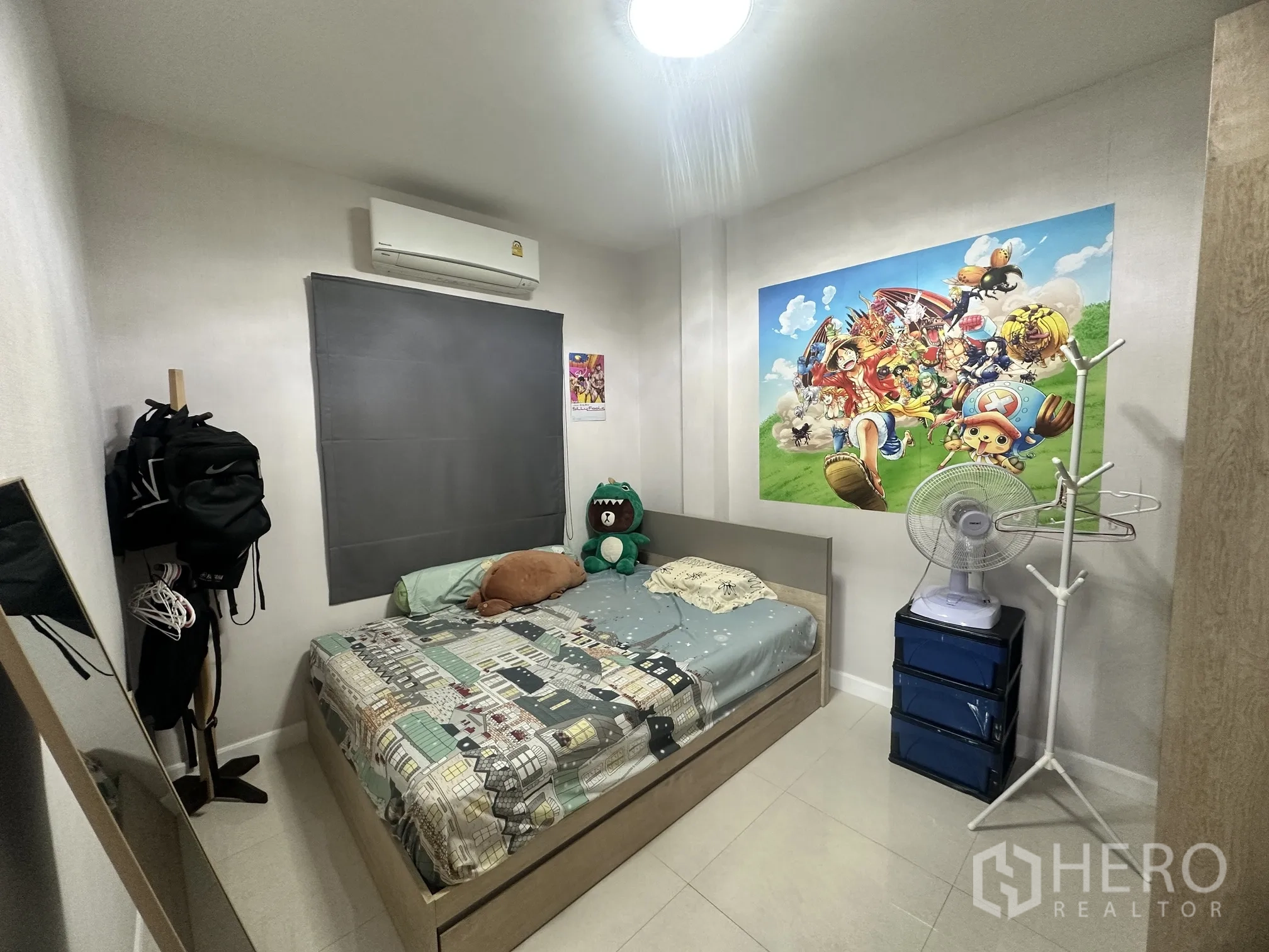 Detached House for sale in Pak Kret, Nonthaburi - Secondary bedroom with single bed, air-conditioner, and wall art.