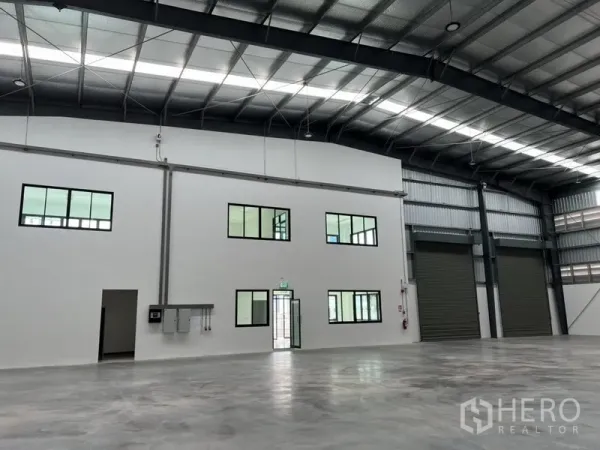 Factory for rent in Bang Sao Thong, Samut Prakan - Warehouse interior showing internal office rooms, entry door and electrical panels.